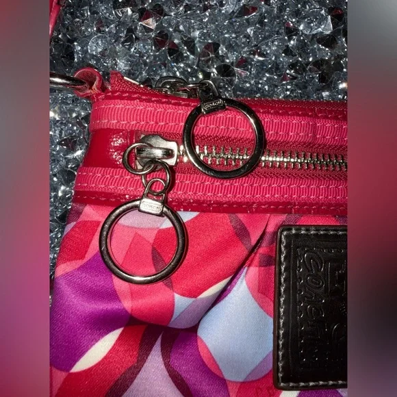 Coach Poppy Wristlet featuring a pink and purple geometric pattern. - Picture 5 of 9